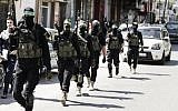 Palestinian Hamas terrorists take part in a military maneuver in Gaza City, on March 25, 2018. (AFP PHOTO / MAHMUD HAMS)