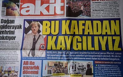 A picture taken on March 26, 2018, in Istanbul shows the front page of the daily Yeni Akit depicting a doctored photo of German Chancellor Angela Merkel in a Nazi-uniform under the headline "We are concerned by this mentality." (AFP Photo/Ozan Kose)