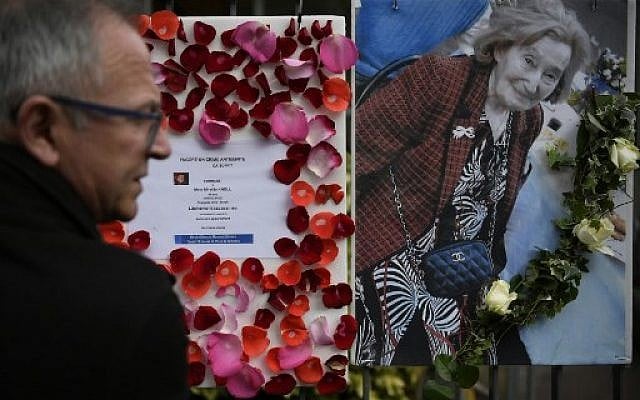 A man stands in front of a picture of Mireille Knoll and a message announcing a "Marche Blanche" condemning the alleged anti-Semitic motive for of her killing, placed on the fence surrounding her building in Paris on March 27, 2018, after she was found dead in her apartment on March 23 by firefighters called to extinguish a blaze.
Two people have been charged with the murder of an 85-year-old French Jewish woman, who was stabbed and whose body was then set alight in a crime being treated as anti-Semitic, a judicial source said on March 27, 2018. ( AFP PHOTO / Lionel BONAVENTURE) A man stands in front of a picture of Mireille Knoll and a message announcing a "Marche Blanche" condemning the alleged anti-Semitic motive for of her killing, placed on the fence surrounding her building in Paris on March 27, 2018, after she was found dead in her apartment on March 23 by firefighters called to extinguish a blaze.
Two people have been charged with the murder of an 85-year-old French Jewish woman, who was stabbed and whose body was then set alight in a crime being treated as anti-Semitic, a judicial source said on March 27, 2018. ( AFP PHOTO / Lionel BONAVENTURE)