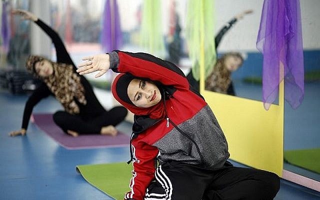 Palestinian women take part in a yoga class at the women's first yoga center in Gaza City on March 28, 2018 (AFP/Mohammed Abed) Palestinian women take part in a yoga class at the women's first yoga center in Gaza City on March 28, 2018 (AFP/Mohammed Abed)