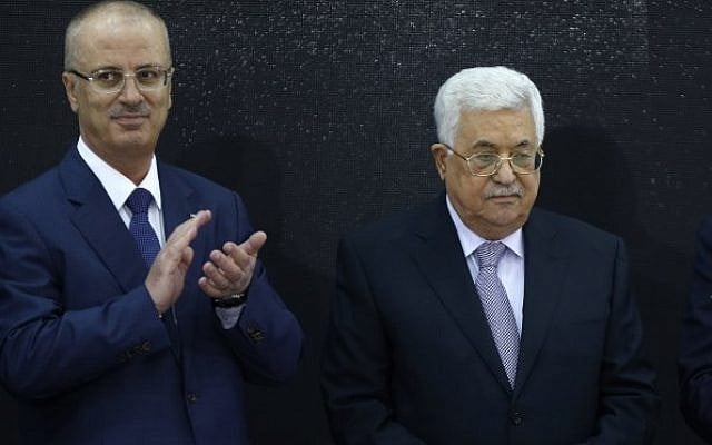 Palestinian Authority President Mahmoud Abbas, right, and Palestinian Prime Minister Rami Hamdallah attend the presentation of the preliminary results of the general census of population, housing and establishments, in Ramallah, in the West Bank on March 28, 2018. (AFP/Abbas Momani) Palestinian Authority President Mahmoud Abbas, right, and Palestinian Prime Minister Rami Hamdallah attend the presentation of the preliminary results of the general census of population, housing and establishments, in Ramallah, in the West Bank on March 28, 2018. (AFP/Abbas Momani)