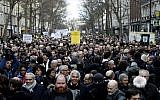 Participants walk behind banners holding placards during a silent march in Paris in memory of Mireille Knoll, an 85-year-old Jewish woman murdered in her home in what police believe was an antisemitic attack, held on on March 28, 2018. (Francois Guillot/AFP)