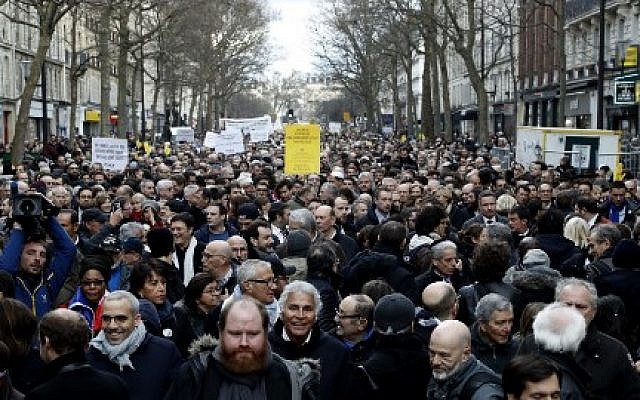 Participants walk behind banners holding placards during a silent march in Paris in memory of Mireille Knoll, an 85-year-old Jewish woman murdered in her home in what police believe was an antisemitic attack, held on on March 28, 2018. (Francois Guillot/AFP) Participants walk behind banners holding placards during a silent march in Paris in memory of Mireille Knoll, an 85-year-old Jewish woman murdered in her home in what police believe was an antisemitic attack, held on on March 28, 2018. (Francois Guillot/AFP)