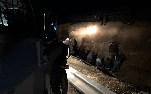 Security forces arrest dozens of Palestinians trying to enter Israel without work permits, south of Jerusalem, on March 4, 2018. (Israel Defense Forces) Security forces arrest dozens of Palestinians trying to enter Israel without work permits, south of Jerusalem, on March 4, 2018. (Israel Defense Forces)