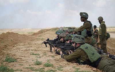 Illustrative: Israeli soldiers prepare for massive protests by Palestinians in Gaza on March 30, 2018. (Israel Defense Forces)