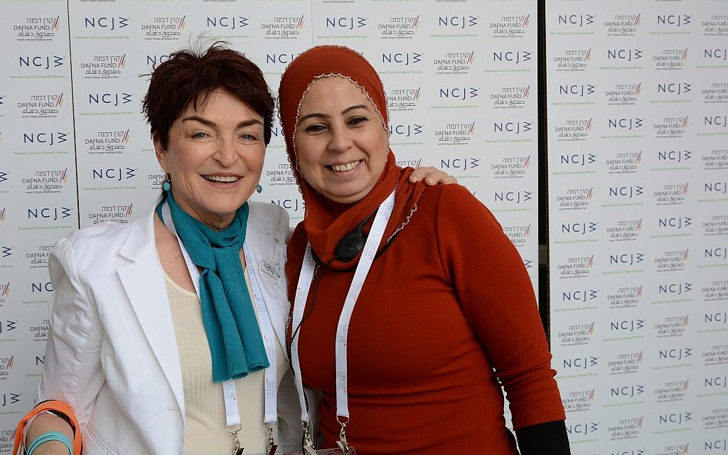 Khitam Zbedat of organization, Women Wage Peace, posing with another symposium attendee. (Gal Mosenson)