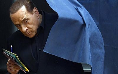 Italian former prime minister and leader of 'Forza Italia' party Silvio Berlusconi votes in a polling station in Milan, March 4, 2018. (Daniel Dal Zennaro/ANSA via AP)