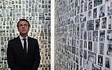 In this photo from April 30, 2017, Emmanuel Macron looks at some of the 2,500 photographs of young Jews deported from France, during a visit to the Shoah memorial in Paris, France. (Philippe Wojazer/Pool Photo via AP, File)