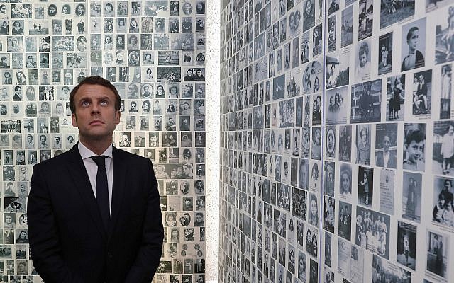In this photo from April 30, 2017, Emmanuel Macron looks at some of the 2,500 photographs of young Jews deported from France, during a visit to the Shoah memorial in Paris, France. (Philippe Wojazer/Pool Photo via AP, File) In this photo from April 30, 2017, Emmanuel Macron looks at some of the 2,500 photographs of young Jews deported from France, during a visit to the Shoah memorial in Paris, France. (Philippe Wojazer/Pool Photo via AP, File)