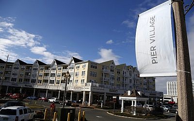 In this Monday, March 5, 2018 photo, the Pier Village development is seen in Long Branch, NJ. The federal government has been advising a beach town on the Jersey Shore on plans to build a pier and start a ferry service that would speed New Yorkers to the doorstep of a resort co-owned by Jared Kushner. (AP Photo/Seth Wenig)