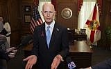 Florida Governor Rick Scott talks to the media in his office after signing the Marjory Stoneman Douglas Public Safety Act at the Florida Capital in Tallahassee, Florida, on March 9, 2018. (AP Photo/Mark Wallheiser)