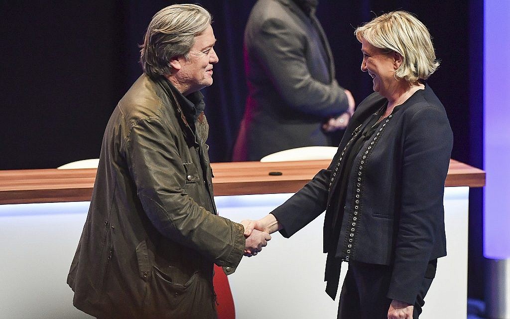 National Front party leader Marine Le Pen, right, greets on stage former White House strategist Steve Bannon at the party congress in the northern French city of Lille, on March 10, 2018. (AP Photo)