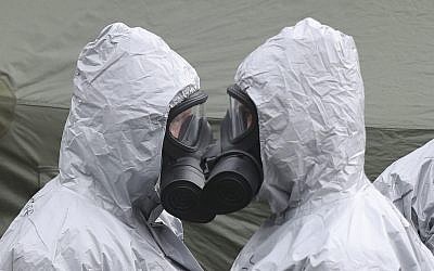 Military personnel in College Street Car Park in Salisbury, Sunday March 11, 2018, as police and members of the armed forces probe the suspected nerve agent attack on Russian double agent Sergei Skripal, which took place on March 4. (Andrew Matthews/PA via AP)