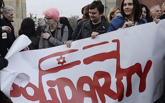 A group hold up a Solidarity banner as hundreds of Poles gathered to express their solidarity with Jews who perished in the Holocaust, were expelled from Poland 50 years ago or feel the effects of anti-Semitism today, in Warsaw, Poland, March 11, 2018. (AP Photo/Czarek Sokolowski) A group hold up a Solidarity banner as hundreds of Poles gathered to express their solidarity with Jews who perished in the Holocaust, were expelled from Poland 50 years ago or feel the effects of anti-Semitism today, in Warsaw, Poland, March 11, 2018. (AP Photo/Czarek Sokolowski)