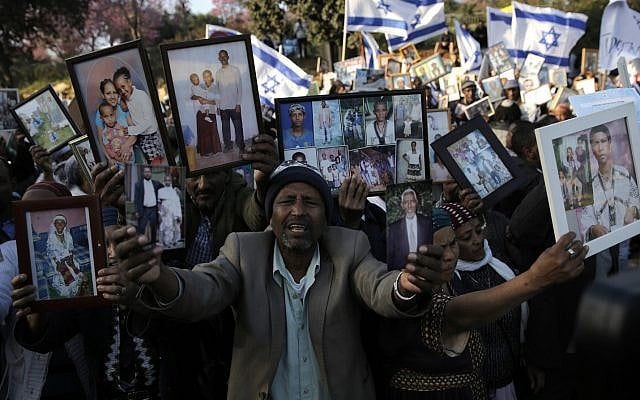 Ethiopian Israelis hold pictures of relatives as they protest in front of the Knesset in Jerusalem, March 12, 2018. (AP Photo/ Sebastian Scheiner) Ethiopian Israelis hold pictures of relatives as they protest in front of the Knesset in Jerusalem, March 12, 2018. (AP Photo/ Sebastian Scheiner)