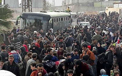 This photo shows Syrian civilians with their belongings, fleeing from fighting between the Syrian government forces and rebels, in eastern Ghouta, a suburb of Damascus, Syria, March. 15, 2018. (SANA via AP)