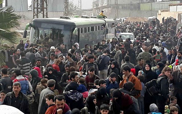 This photo shows Syrian civilians with their belongings, fleeing from fighting between the Syrian government forces and rebels, in eastern Ghouta, a suburb of Damascus, Syria, March. 15, 2018. (SANA via AP) This photo shows Syrian civilians with their belongings, fleeing from fighting between the Syrian government forces and rebels, in eastern Ghouta, a suburb of Damascus, Syria, March. 15, 2018. (SANA via AP)
