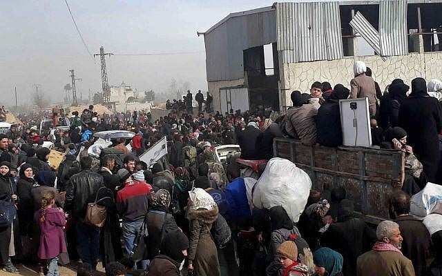 This photo released by the Syrian official news agency SANA, shows Syrian civilians with their belongings as they flee from fighting between the Syrian government forces and rebels, in Hamouria in eastern Ghouta, a suburb of Damascus, Syria, Thursday, March. 15, 2018. (SANA via AP) This photo released by the Syrian official news agency SANA, shows Syrian civilians with their belongings as they flee from fighting between the Syrian government forces and rebels, in Hamouria in eastern Ghouta, a suburb of Damascus, Syria, Thursday, March. 15, 2018. (SANA via AP)