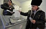 Two men cast their ballots at a polling station in Yelizovo, about 30 kilometers ( 19 miles) north-east from Petropavlovsk-Kamchatsky, capital of Kamchatka Peninsula region, Russian Far East, Russia, on Sunday, March. 18, 2018. (AP Photo/Alexander Petpov)