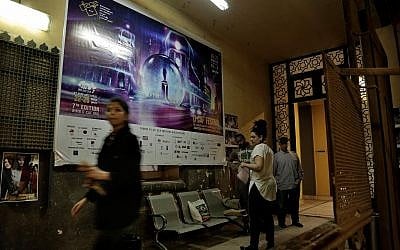 In this March 14, 2018 photo, staff working for the Downtown Contemporary Arts Festival walk outside their office in Cairo. (AP Photo/Nariman El-Mofty)