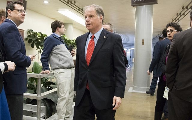 Sen. Doug Jones, an Alabama Democrat, heads to the Senate to vote on the bipartisan "Stop Enabling Sex Traffickers Act" which would allow victims of sex trafficking to sue websites that enabled their abuse, on Capitol Hill in Washington, Wednesday, March 21, 2018. (AP Photo/J. Scott Applewhite) Sen. Doug Jones, an Alabama Democrat, heads to the Senate to vote on the bipartisan "Stop Enabling Sex Traffickers Act" which would allow victims of sex trafficking to sue websites that enabled their abuse, on Capitol Hill in Washington, Wednesday, March 21, 2018. (AP Photo/J. Scott Applewhite)