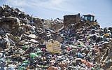 In this March 13, 2018 photo, a tractor works at a landfill near the UBQ factory in Kibbutz Tzeelim in southern Israel. (AP Photo/Ariel Schalit)
