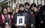 Ilan Alhadeff, joined at left by his wife Lori Alhadeff, holds a photograph of their daughter, Alyssa Alhadeff, 14, who was killed at Marjory Stoneman Douglas High School in Parkland, Fla., during a rally in support of gun control at the U.S. Capitol in Washington, Friday, March 23, 2018. (AP Photo/J. Scott Applewhite)