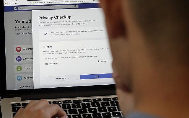In this March 26, 2018, photo, a man poses in front of a computer showing Facebook ad preferences pages in San Francisco. (AP Photo/Jeff Chiu) In this March 26, 2018, photo, a man poses in front of a computer showing Facebook ad preferences pages in San Francisco. (AP Photo/Jeff Chiu)
