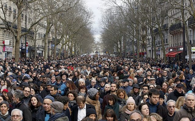 People attend a silent march to honor an 85-year-old woman who escaped the Nazis 76 years ago but was stabbed to death last week in her Paris apartment, apparently targeted because she was Jewish, and to denounce racism, in Paris, France on, March 28, 2018. (AP Photo/Thibault Camus)