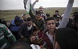 Palestinians chant slogans as they attend a demonstration near the Gaza Strip border with Israel, in eastern Gaza City, Friday, March 30, 2018. (AP Photo/Khalil Hamra)