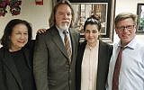 In this Friday, March 30, 2018 photo, Noor Salman, second from right, and her attorneys pose for a photo after Salman was acquitted of lying to the FBI and helping her husband attack the Pulse nightclub in Orlando, Fla. The attorneys, Linda Moreno, Fritz Scheller, Charles Swift pose with Salman from left. (Susan Clary via AP)