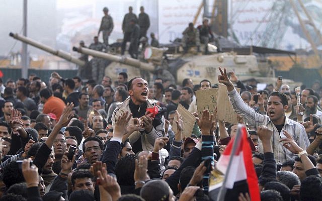 Egyptians protest in front of an army tank in central Cairo, Egypt, January 29, 2011. (AP Photo/Ahmed Ali) Egyptians protest in front of an army tank in central Cairo, Egypt, January 29, 2011. (AP Photo/Ahmed Ali)