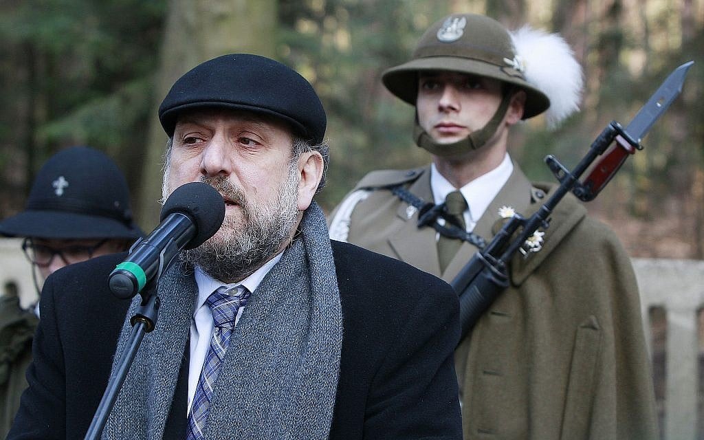 Chief Rabi of Poland, Michael Schudrich, says prayers for the dead at a cemetery where eight Jews killed by the Germans in 1944 were buried, along with the Polish Ulma family that was sheltering them, in Jagiella, Poland, on Thursday, March 17, 2016 during ceremonies honoring the Ulmas and hundreds of Poles who lost their lives trying to save Jews in the Holocaust. (AP Photo/Czarek Sokolowski) Chief Rabi of Poland, Michael Schudrich, says prayers for the dead at a cemetery where eight Jews killed by the Germans in 1944 were buried, along with the Polish Ulma family that was sheltering them, in Jagiella, Poland, on Thursday, March 17, 2016 during ceremonies honoring the Ulmas and hundreds of Poles who lost their lives trying to save Jews in the Holocaust. (AP Photo/Czarek Sokolowski)