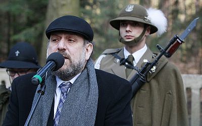 Chief Rabi of Poland, Michael Schudrich, says prayers for the dead at a cemetery where eight Jews killed by the Germans in 1944 were buried, along with the Polish Ulma family that was sheltering them, in Jagiella, Poland, on Thursday, March 17, 2016 during ceremonies honoring the Ulmas and hundreds of Poles who lost their lives trying to save Jews in the Holocaust. (AP Photo/Czarek Sokolowski)