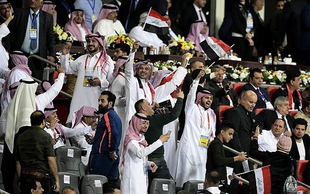 Iraqi and Saudi soccer fans cheer, waving national flags during a friendly soccer match between Iraq and Saudi Arabia in Basra, 550 kilometers (340 miles) southeast of Baghdad, Iraq, Wednesday, Feb. 28, 2018. (AP Photo/Nabil al-Jurani) Iraqi and Saudi soccer fans cheer, waving national flags during a friendly soccer match between Iraq and Saudi Arabia in Basra, 550 kilometers (340 miles) southeast of Baghdad, Iraq, Wednesday, Feb. 28, 2018. (AP Photo/Nabil al-Jurani)