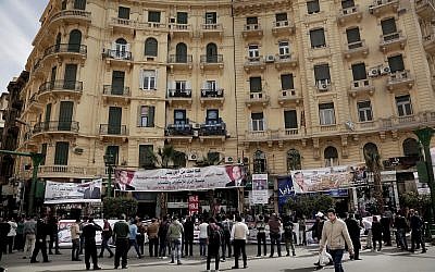 People hold banners of Egyptian presidential candidate Moussa Mustafa Moussa on a street in downtown Cairo, Egypt, Sunday, March 4, 2018. (AP Photo/Nariman El-Mofty)