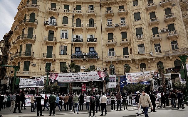 People hold banners of Egyptian presidential candidate Moussa Mustafa Moussa on a street in downtown Cairo, Egypt, Sunday, March 4, 2018. (AP Photo/Nariman El-Mofty)
