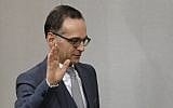 German Foreign Minister Heiko Maas takes the oath of office after the new government was appointed after German Chancellor Angela Merkel was elected for a fourth term as chancellor in the German parliament Bundestag in Berlin, Germany, Wednesday, March 14, 2018. (AP Photo/Michael Sohn)