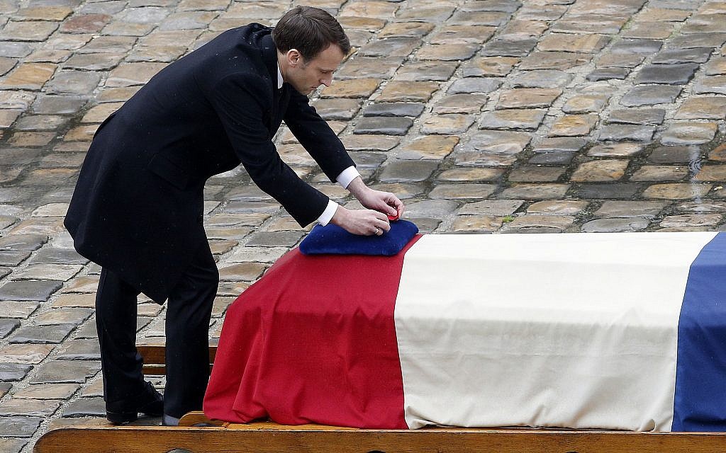 French President Emmanuel Macron posthumously awards the Legion of Honor to Lt. Col. Arnaud Beltrame during a ceremony Wednesday March 28, 2018 at the Hotel des Invalides in Paris. (AP Photo/Christophe Ena)