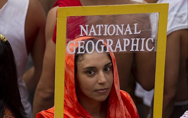 A reveler holds a frame depicting a front page of National Geographic magazine during "Ceu na Terra" block carnival parade in Rio de Janeiro, Brazil, Saturday, February 9, 2013. (AP Photo/Silvia Izquierdo) A reveler holds a frame depicting a front page of National Geographic magazine during "Ceu na Terra" block carnival parade in Rio de Janeiro, Brazil, Saturday, February 9, 2013. (AP Photo/Silvia Izquierdo)