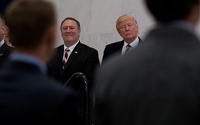 US President Donald Trump, accompanied by CIA Director-designate Rep. Michael Pompeo, left, waits to speak at the Central Intelligence Agency in Langley, Virginia, Saturday, January 21, 2017. (AP Photo/Andrew Harnik)