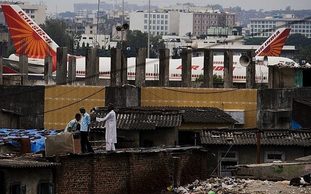In this Sept. 28, 2009 file photo, Air India passenger jets are parked in the background of slums adjoining the international airport in Mumbai, India.(AP Photo/Dhiraj Singh) In this Sept. 28, 2009 file photo, Air India passenger jets are parked in the background of slums adjoining the international airport in Mumbai, India.(AP Photo/Dhiraj Singh)
