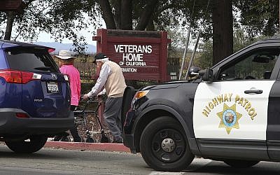 People walk to the information center at the Veterans Home of California in Yountville, California, on Friday March 9, 2018. (AP Photo/Ben Margot)