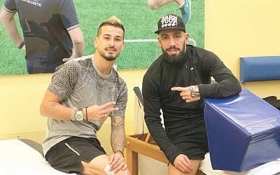 Illustrative photo of Israeli soccer player Maor Buzaglo (L) posing alongside Iranian national team captain Ashkan Dejagah on Sunday, March 18, 2018. (Twitter)