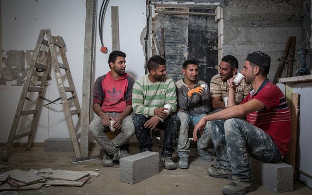 File: Palestinian construction workers from the West Bank village of Abadiya, during their coffee break at a house under renovation in the Jewish settlement of Alon, south of Jerusalem, on February 16, 2016. (Hadas Parush/Flash90) File: Palestinian construction workers from the West Bank village of Abadiya, during their coffee break at a house under renovation in the Jewish settlement of Alon, south of Jerusalem, on February 16, 2016. (Hadas Parush/Flash90)