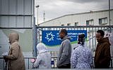 Illustrative photo of asylum seekers waiting outside the Israeli Population and Immigration Authority office waiting to find out their status, in Bnei Brak, Israel, February 13, 2018. (Miriam Alster/FLASH90)