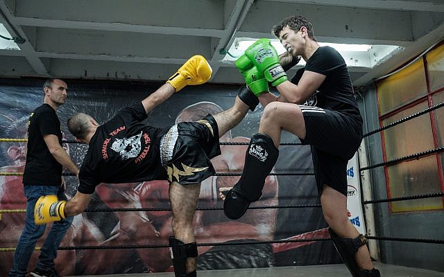 Fighters exchange kicks during a kickboxing competition at Nakash Boxing Gym in Tel Aviv, March 10, 2018. (Yaniv Nadav/Flash90) Fighters exchange kicks during a kickboxing competition at Nakash Boxing Gym in Tel Aviv, March 10, 2018. (Yaniv Nadav/Flash90)