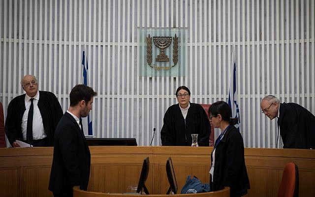 Supreme Court President Esther Hayut (C) and judges Hanan Melcer and Neil Hendel arrive to hear an an appeal against deportation of African asylum seekers at the Supreme Court in Jerusalem on March 12, 2018. (Hadas Parush/Flash90) Supreme Court President Esther Hayut (C) and judges Hanan Melcer and Neil Hendel arrive to hear an an appeal against deportation of African asylum seekers at the Supreme Court in Jerusalem on March 12, 2018. (Hadas Parush/Flash90)