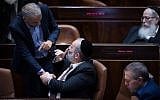 Finance Minister Moshe Kahlon, left, shakes hands with Interior Minister Aryeh Deri in the Knesset on March 13, 2018. (Hadas Parush/Flash90)
