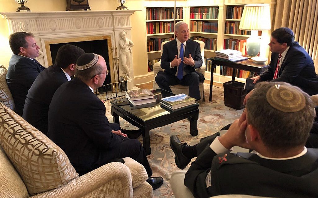 Prime Minister Benjamin Netanyahu consults with his advisers before meeting US President Donald Trump at the White House on March 5, 2018. (Haim Zach/GPO)